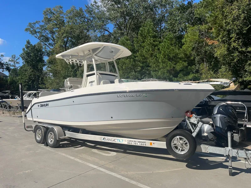 The Image of 2018 Century 2301 Center Console boat on trailer, parked outdoors. - 1