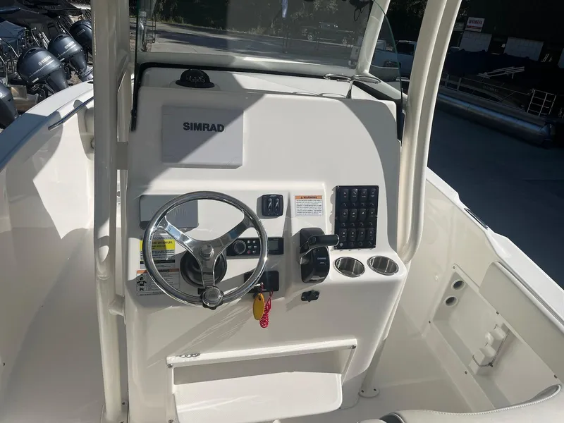 Slide: The Image of 2018 Century 2301 Center Console boat dashboard with steering wheel and controls. - 4