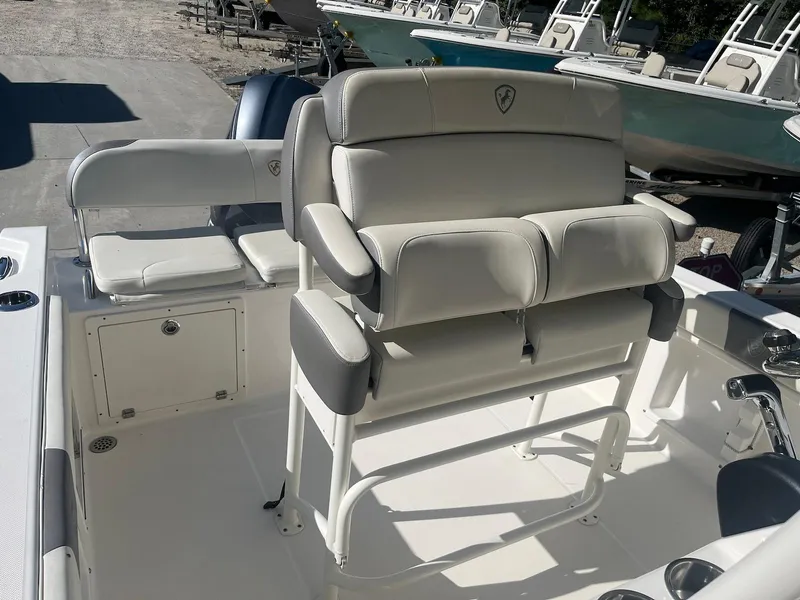 Slide: The Image of 2018 Century 2301 Center Console boat interior with cushioned seating and storage. - 6