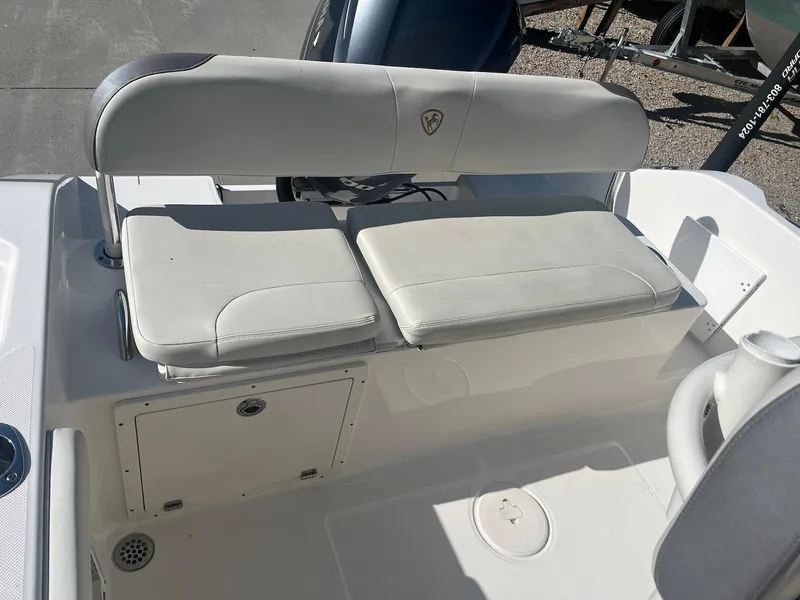 Slide: The Image of 2018 Century 2301 Center Console boat seating area with cushioned bench. - 7