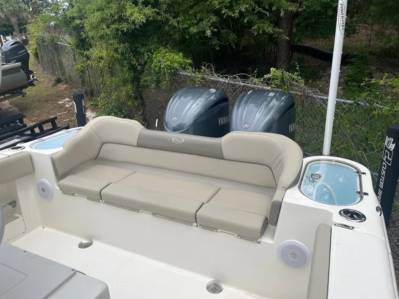 Slide: The Image of 2022 Key West 263 FS boat with beige seating and dual Yamaha engines. - 11