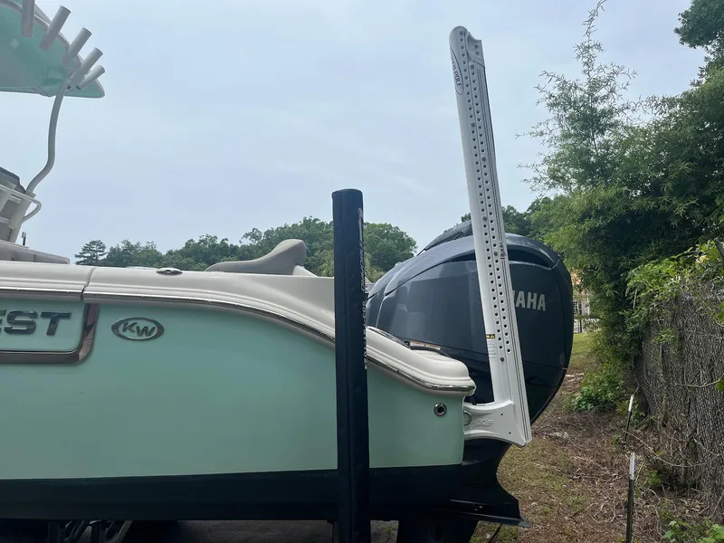 Slide: The Image of 2022 Key West 263 FS boat with Yamaha engine, parked outdoors. - 2