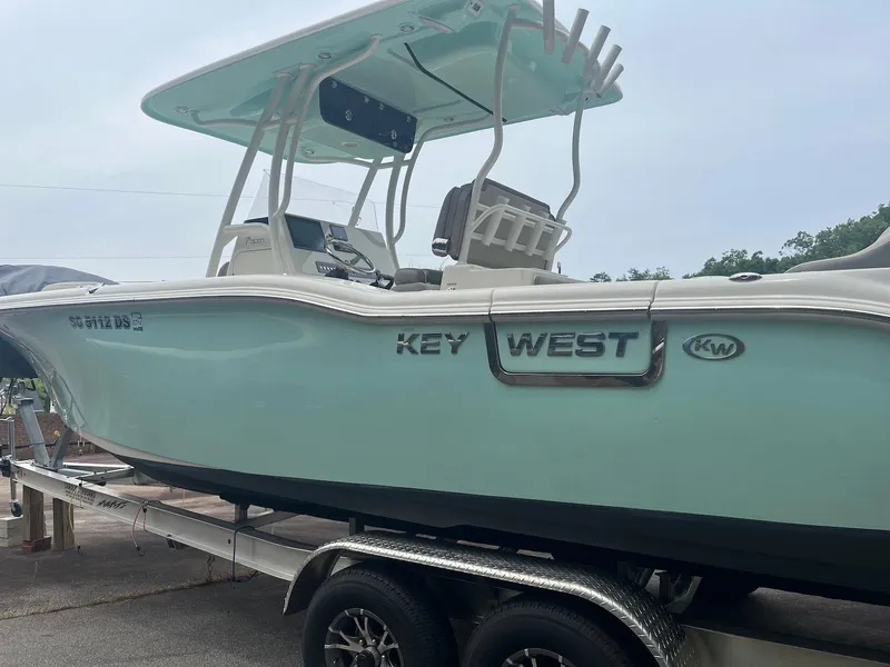 Slide: The Image of 2022 Key West 263 FS boat on trailer, side view, light blue hull. - 3
