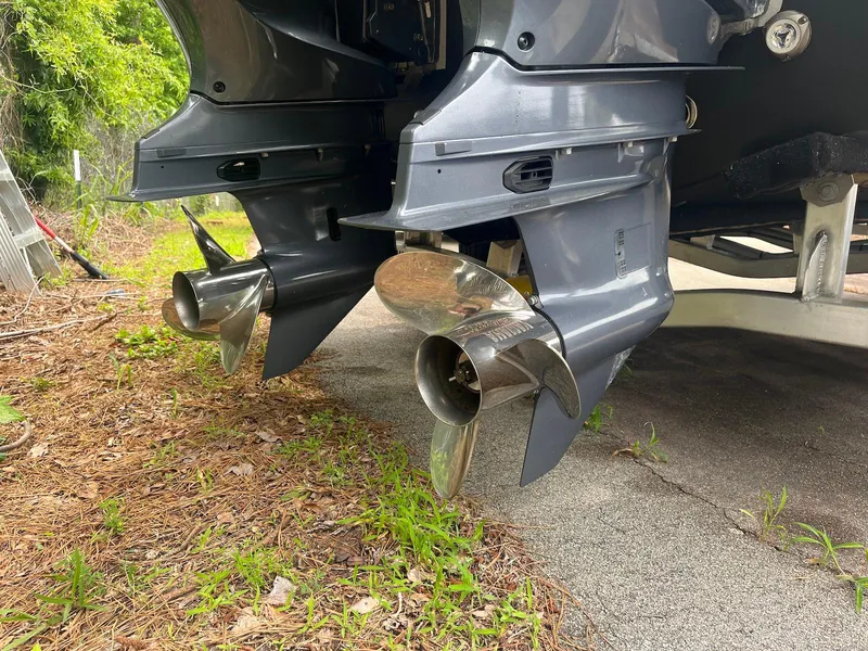 Slide: The Image of 2022 Key West 263 FS boat propellers on a trailer, surrounded by grass and pavement. - 5