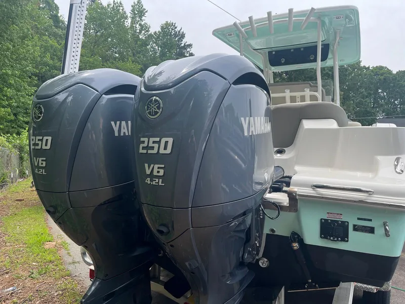 Slide: The Image of 2022 Key West 263 FS boat with dual Yamaha 250 V6 engines, outdoor setting. - 6