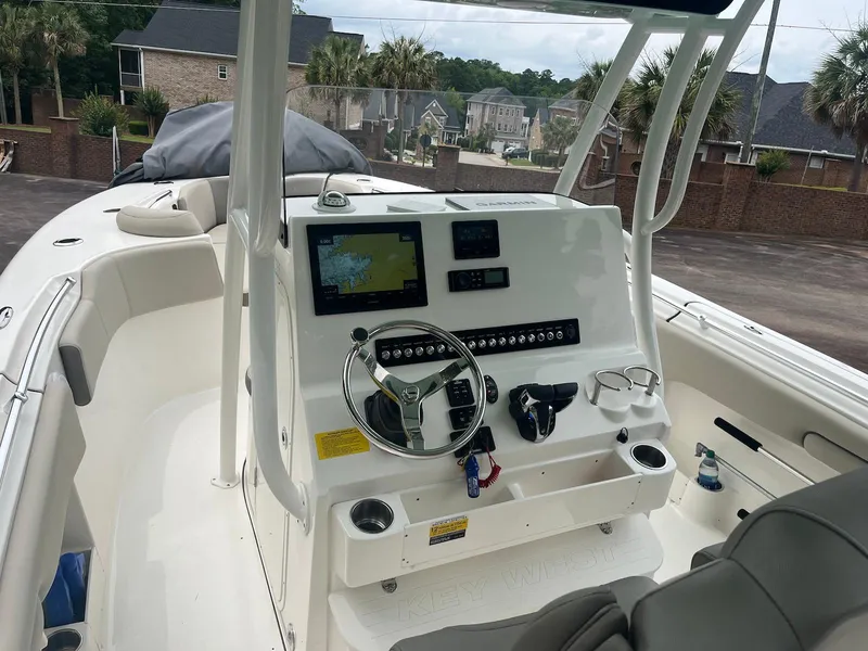 Slide: The Image of 2022 Key West 263 FS boat dashboard with navigation screen and steering wheel. - 7