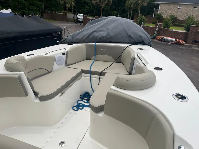 Slide: The Image of 2022 Key West 263 FS boat with beige seating and blue rope on deck. - 8