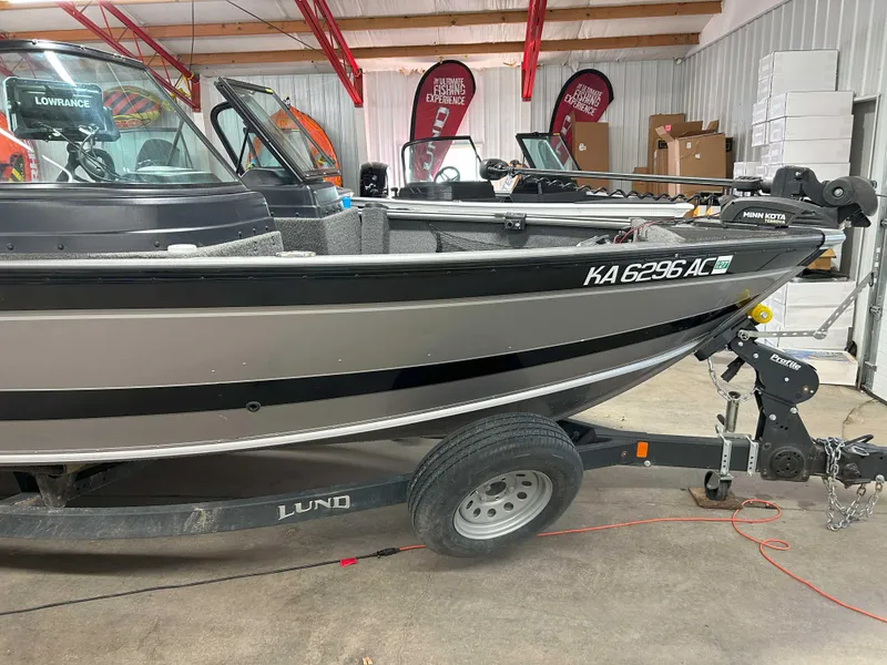 Slide: The Image of 2021 Lund 1875 Impact XS boat in showroom, side view with trailer. - 3