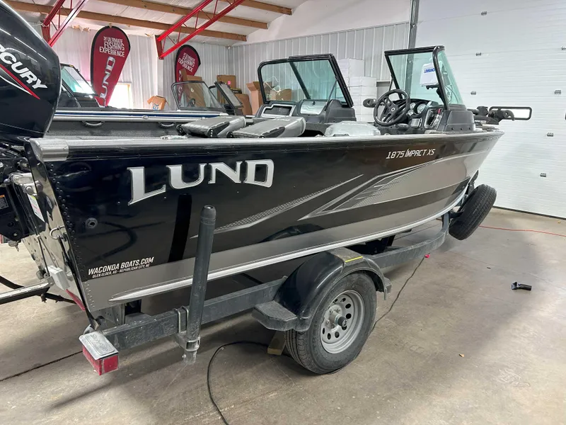 Slide: The Image of 2021 Lund 1875 Impact XS boat on trailer in indoor showroom. - 4