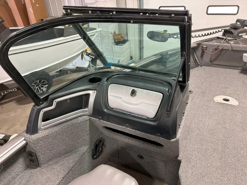 Slide: The Image of 2021 Lund 1875 Impact XS boat interior with windshield and storage compartment. - 7
