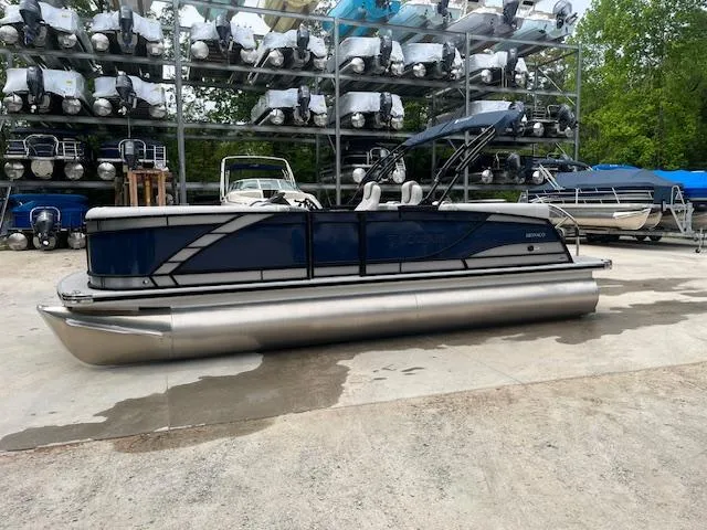 Slide: The Image of 2024 Godfrey Monaco 235 SB pontoon boat in storage yard, surrounded by other boats. - 3