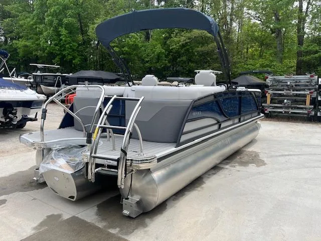 Slide: The Image of 2024 Godfrey Monaco 235 SB pontoon boat with canopy, parked outdoors. - 5