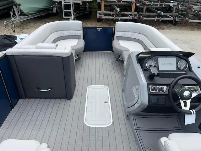 Slide: The Image of 2024 Godfrey Monaco 235 SB boat interior with seating and steering console. - 7