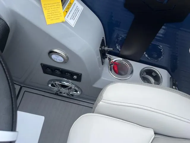 Slide: The Image of 2024 Godfrey Monaco 235 SB boat interior with control panel and cup holders. - 9