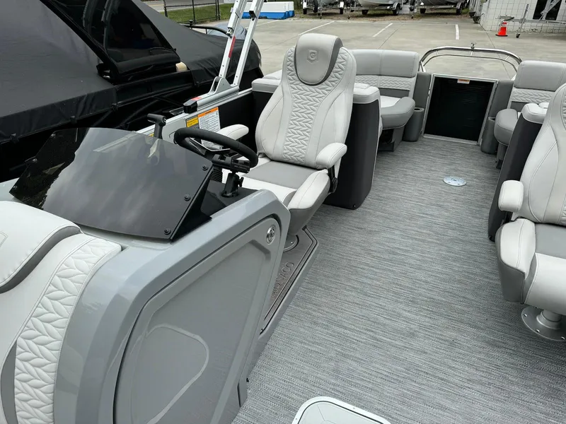 Slide: The Image of 2024 Godfrey Monaco 235 SB boat interior with luxurious seating and modern dashboard. - 12