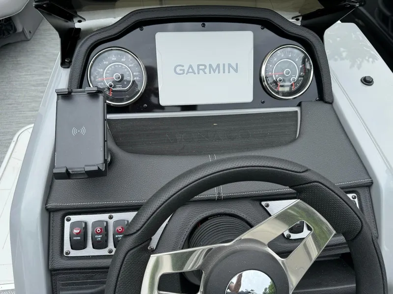 Slide: The Image of 2024 Godfrey Monaco 235 SB dashboard with Garmin display and steering wheel. - 14