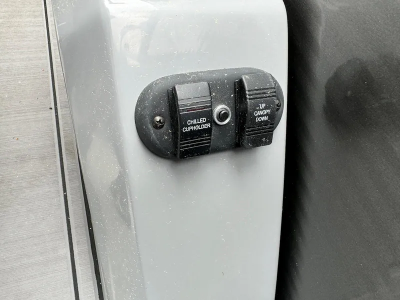 Slide: The Image of Chilled cupholder and canopy controls on 2024 Godfrey Monaco 235 SB boat. - 17