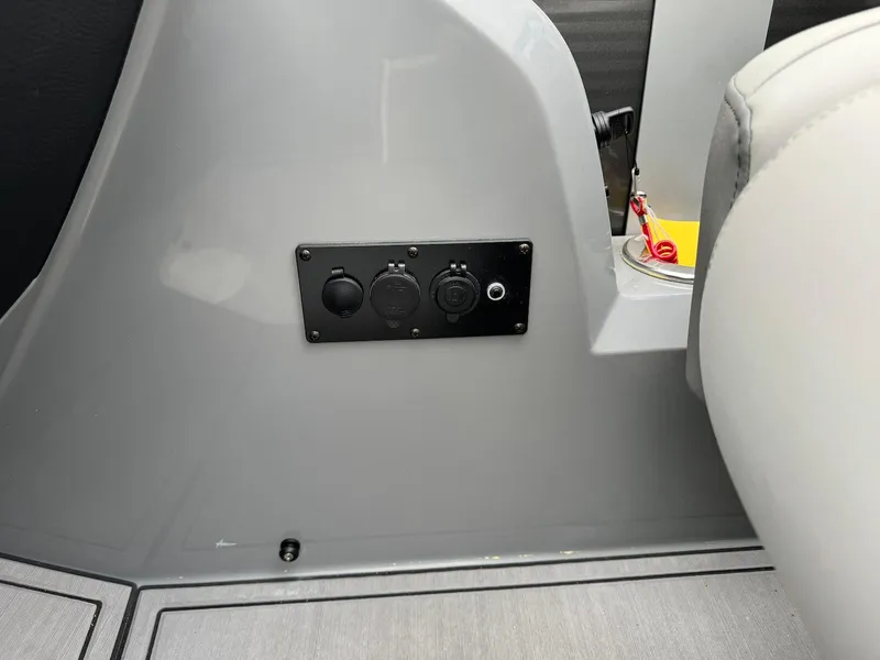 Slide: The Image of 2024 Godfrey Monaco 235 SB boat interior with control panel and seating. - 18