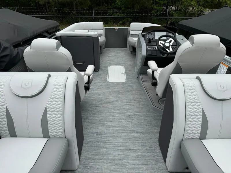Slide: The Image of 2024 Godfrey Monaco 235 SB boat interior with luxurious seating and modern dashboard. - 19