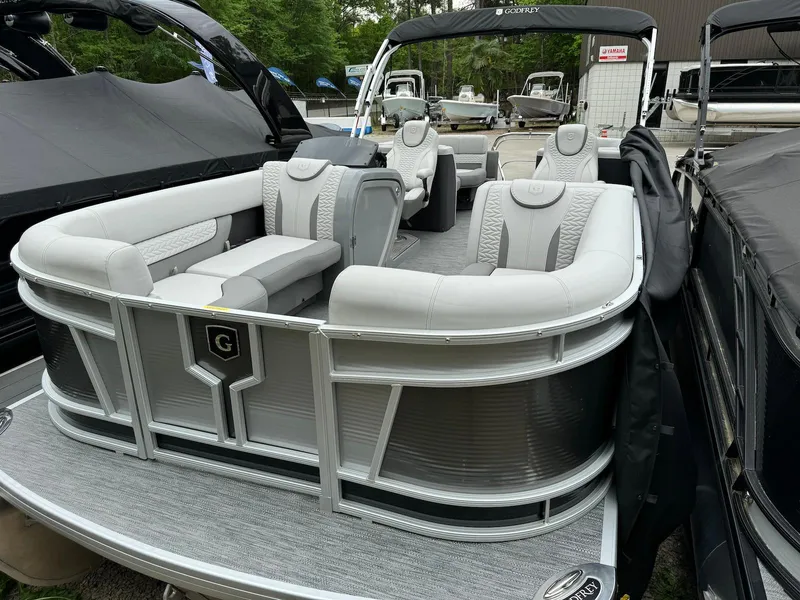 Slide: The Image of 2024 Godfrey Monaco 235 SB pontoon boat with luxurious seating and sleek design. - 2