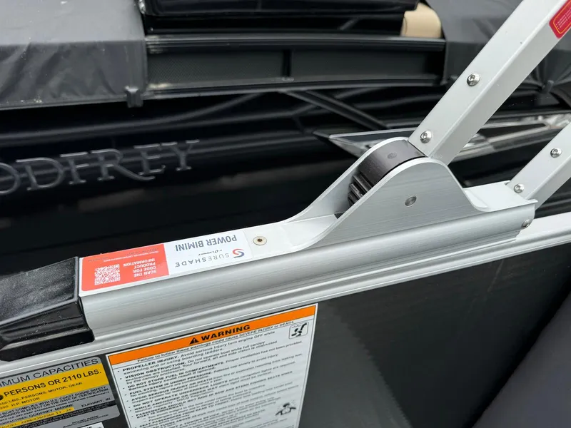 Slide: The Image of 2024 Godfrey Monaco 235 SB boat detail with safety warning labels and structural components. - 25