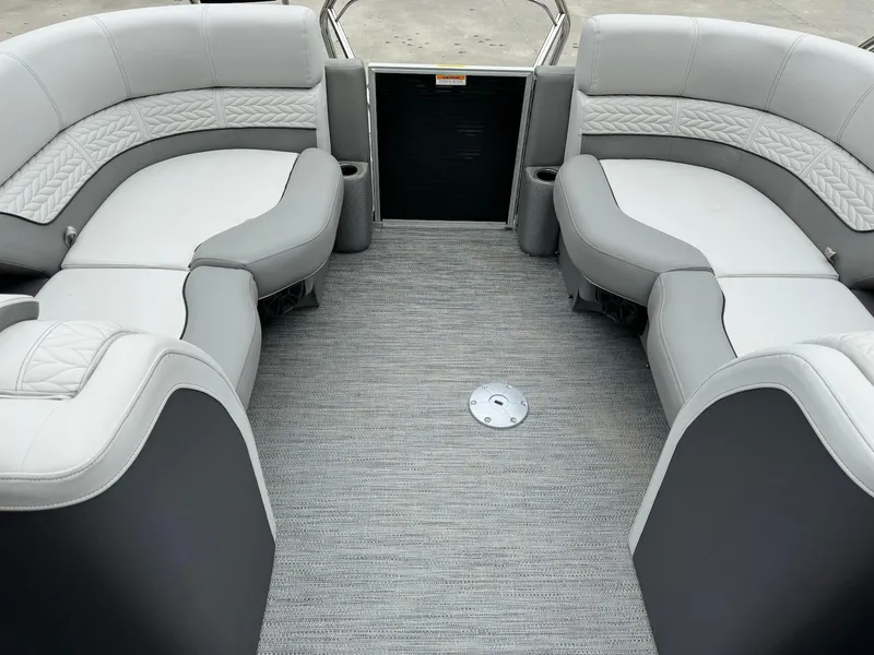 Slide: The Image of 2024 Godfrey Monaco 235 SB boat interior with gray seating and carpeted floor. - 6