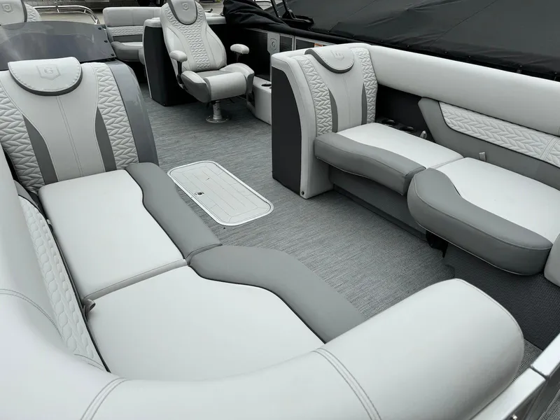 Slide: The Image of 2024 Godfrey Monaco 235 SB boat interior with luxurious gray seating and modern design. - 7