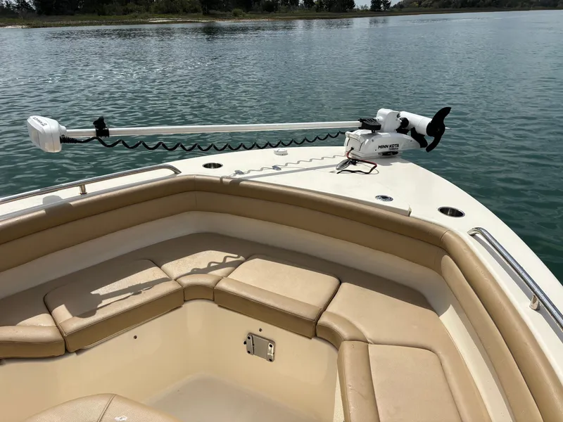 Slide: The Image of 2021 Scout 215XSF boat with Minn Kota trolling motor on calm water. - 12