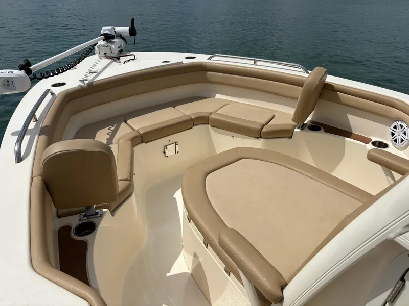 Slide: The Image of 2021 Scout 215XSF boat interior with tan seating and trolling motor. - 14