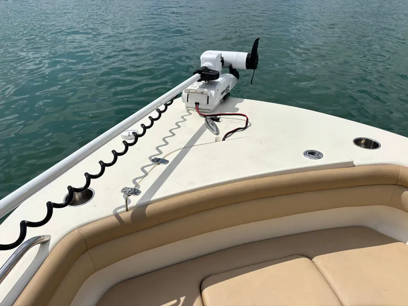 Slide: The Image of 2021 Scout 215XSF boat with trolling motor on calm water. - 16