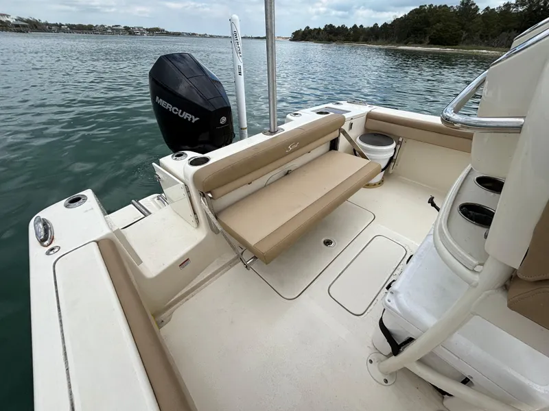 Slide: The Image of 2021 Scout 215XSF boat interior with Mercury engine on calm water. - 27