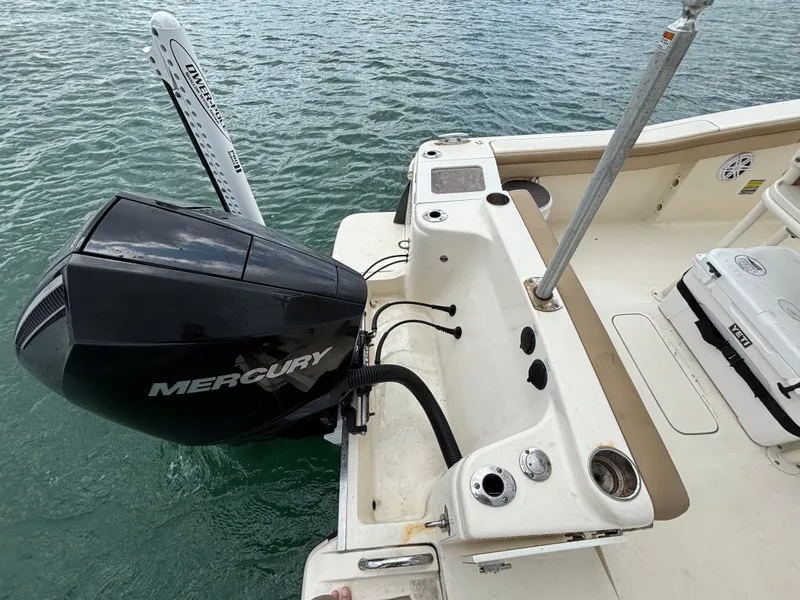 Slide: The Image of 2021 Scout 215XSF boat with Mercury engine on water. - 34