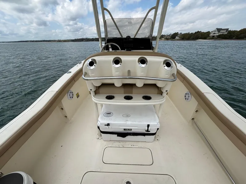 Slide: The Image of 2021 Scout 215XSF boat interior with seating and storage on calm water. - 35