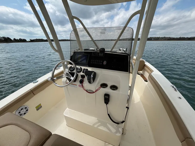 Slide: The Image of 2021 Scout 215XSF boat interior with steering console on open water. - 37