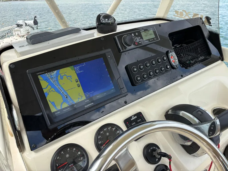 Slide: The Image of 2021 Scout 215XSF boat dashboard with Garmin GPS and control panel. - 39