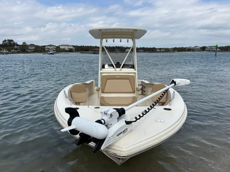 Slide: The Image of 2021 Scout 215XSF boat with Minn Kota motor on calm water. - 4