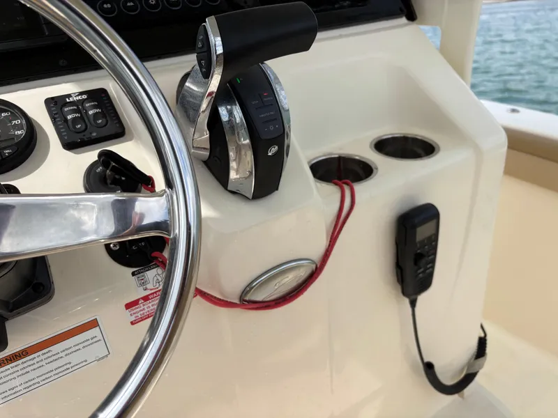 Slide: The Image of 2021 Scout 215XSF boat dashboard with steering wheel and controls. - 41