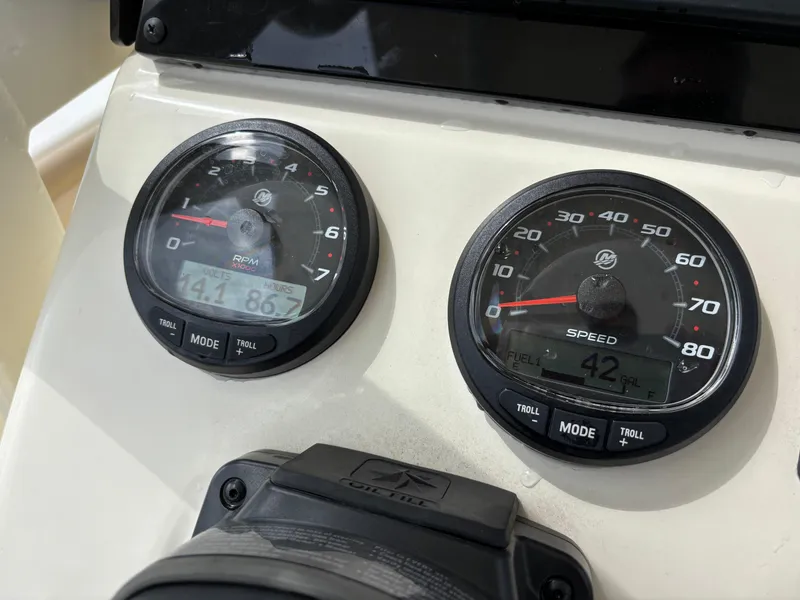 Slide: The Image of 2021 Scout 215XSF boat dashboard with RPM and speed gauges. - 42