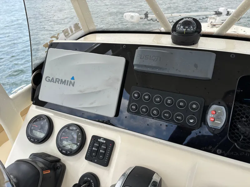 Slide: The Image of 2021 Scout 215XSF boat dashboard with Garmin navigation, compass, and control panel. - 43