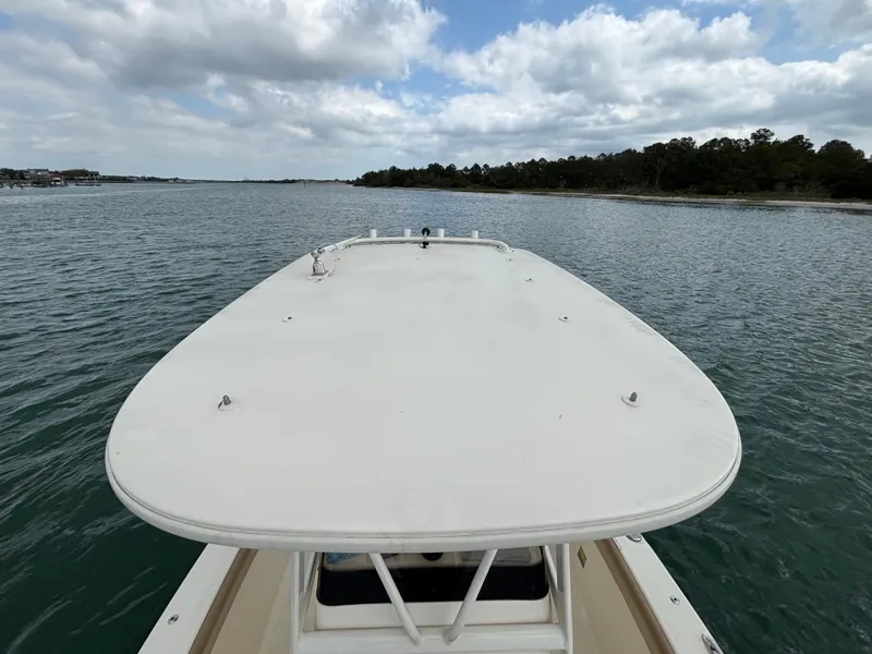Slide: The Image of 2021 Scout 215XSF boat on calm water under cloudy sky. - 44