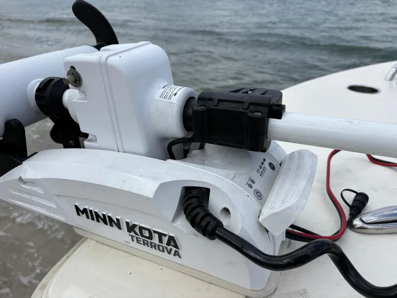 Slide: The Image of Minn Kota Terrova motor on 2021 Scout 215XSF boat by the water. - 47