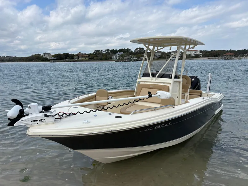 Slide: The Image of 2021 Scout 215XSF boat with Minn Kota motor on calm water. - 5