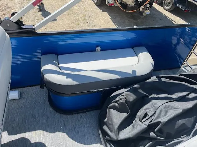 Slide: The Image of 2023 Godfrey SWEETWATER 2286 SFL boat interior with blue and gray seating. - 10