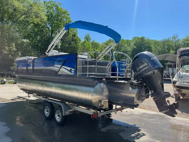 Slide: The Image of 2023 Godfrey SWEETWATER 2286 SFL pontoon boat on trailer, blue canopy, Yamaha motor. - 2