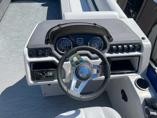Slide: The Image of 2023 Godfrey SWEETWATER 2286 SFL boat dashboard with steering wheel and controls. - 7