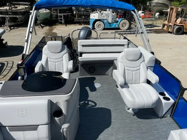 Slide: The Image of 2023 Godfrey SWEETWATER 2286 SFL pontoon boat with plush seating and blue canopy. - 8