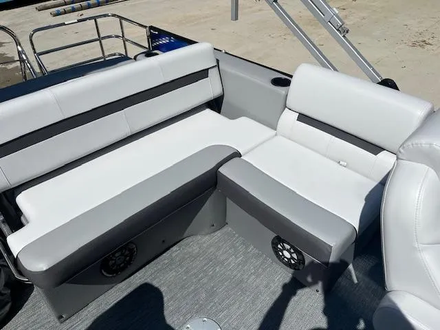 Slide: The Image of 2023 Godfrey SWEETWATER 2286 SFL boat interior with white and gray seating. - 9