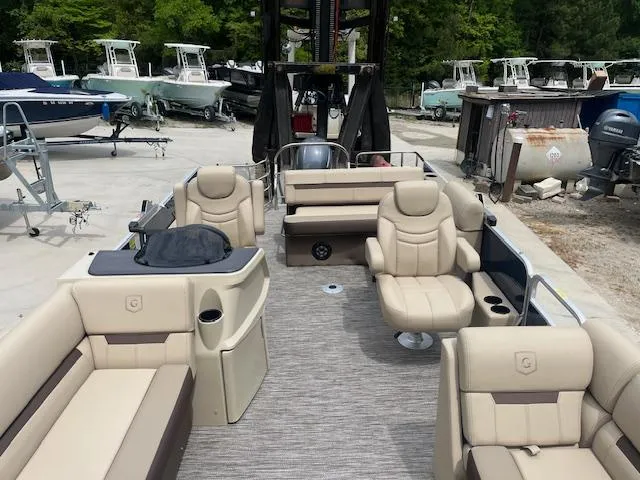 Slide: The Image of 2023 Godfrey SWEETWATER 2286 SFL pontoon boat with beige seating, docked outdoors. - 5
