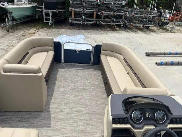 Slide: The Image of 2023 Godfrey SWEETWATER 2286 SFL pontoon boat interior with beige seating and control panel. - 6