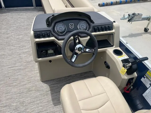 Slide: The Image of 2023 Godfrey SWEETWATER 2286 SFL boat dashboard with steering wheel and controls. - 7